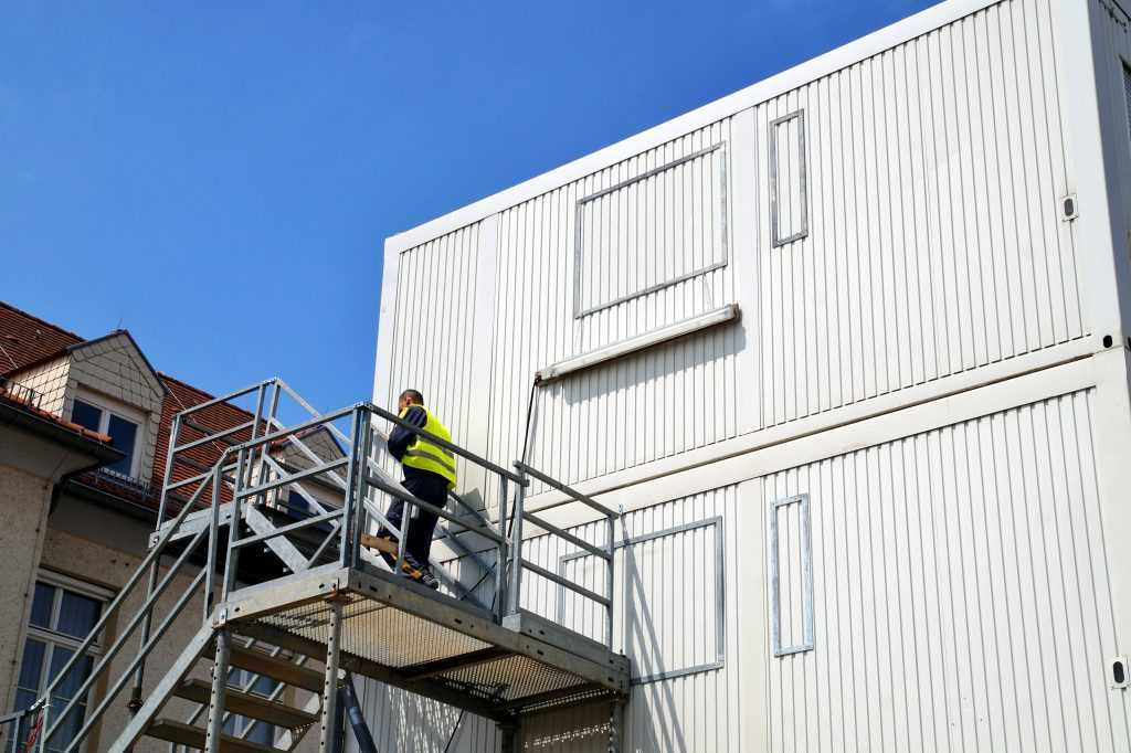 Temporary shelter for workers. Cargo container houses. Tiny living in container boxes